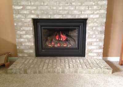 gas fireplace with white brick surround