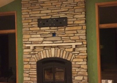 gas fireplace insert with stone surround and small stone mantel