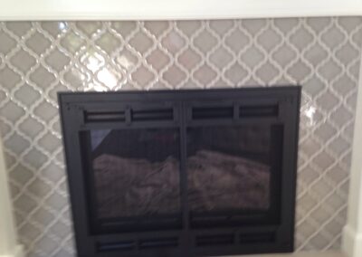 gas fireplace with elegant tile surround and white mantel