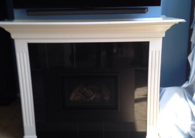 gas fireplace with white wooden surround and mantel