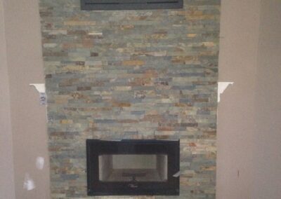 wood-burning fireplace with custom stone surround