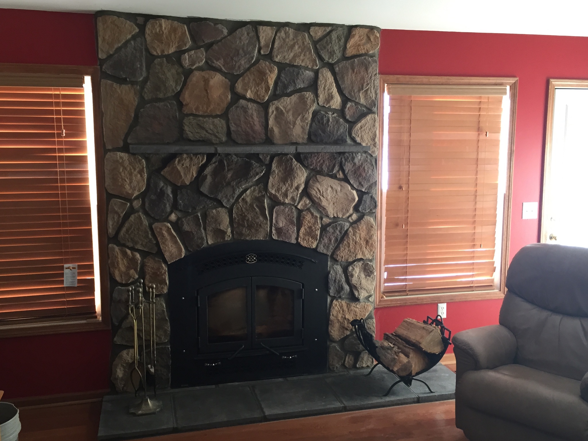 wood burning fireplace with stone surround