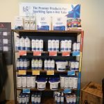 The image shows a shelf featuring some of the products we carry to take care of your hot tub