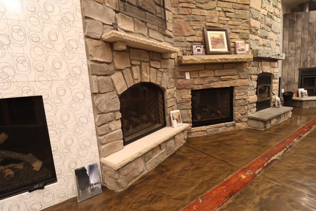 The image shows several different fireplace examples in our showroom
